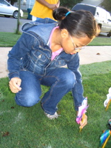 Joy Hocutt planting a pinwheel, 5th grade